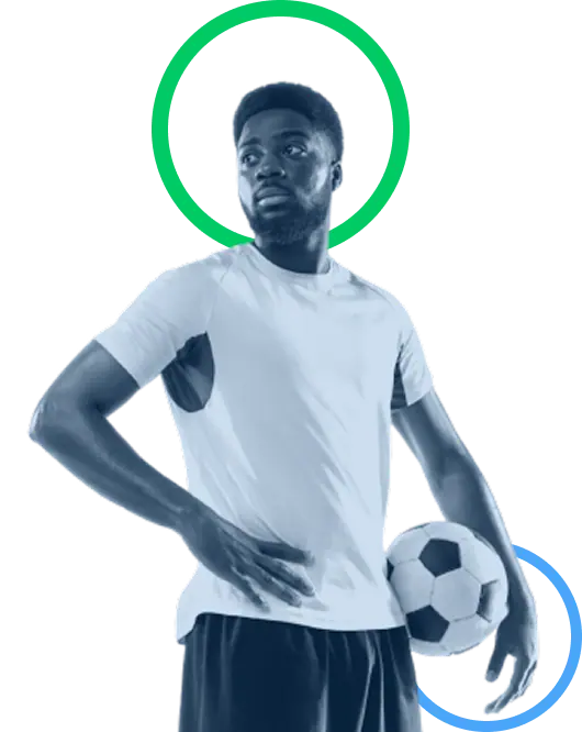 Footballer holding a ball, ready to step onto the pitch